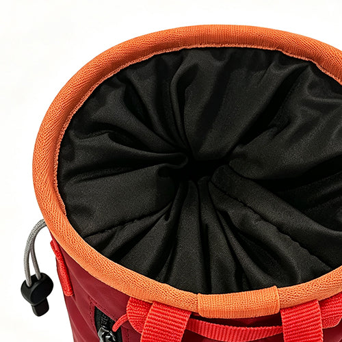Drawstring closure effectively minimizes chalk spillage.
