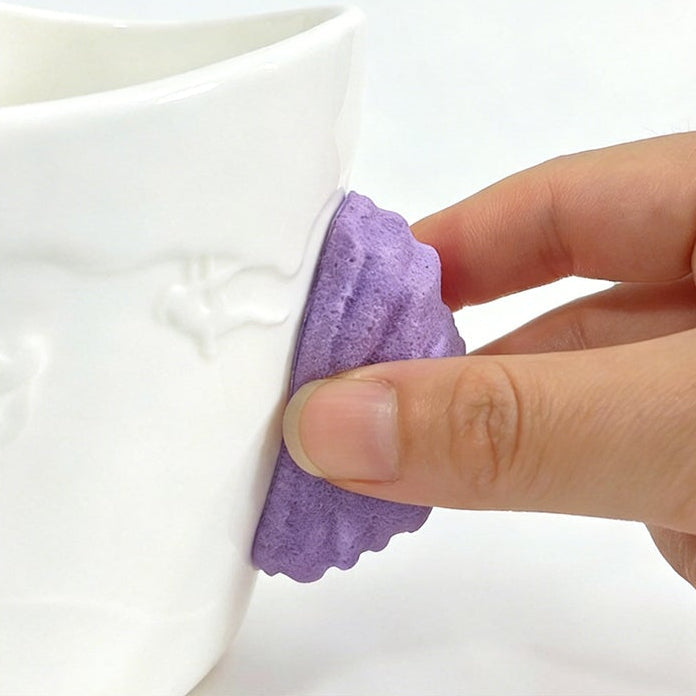 Close-up of the 3D climbing hold handle on a ceramic rock climbing mug
