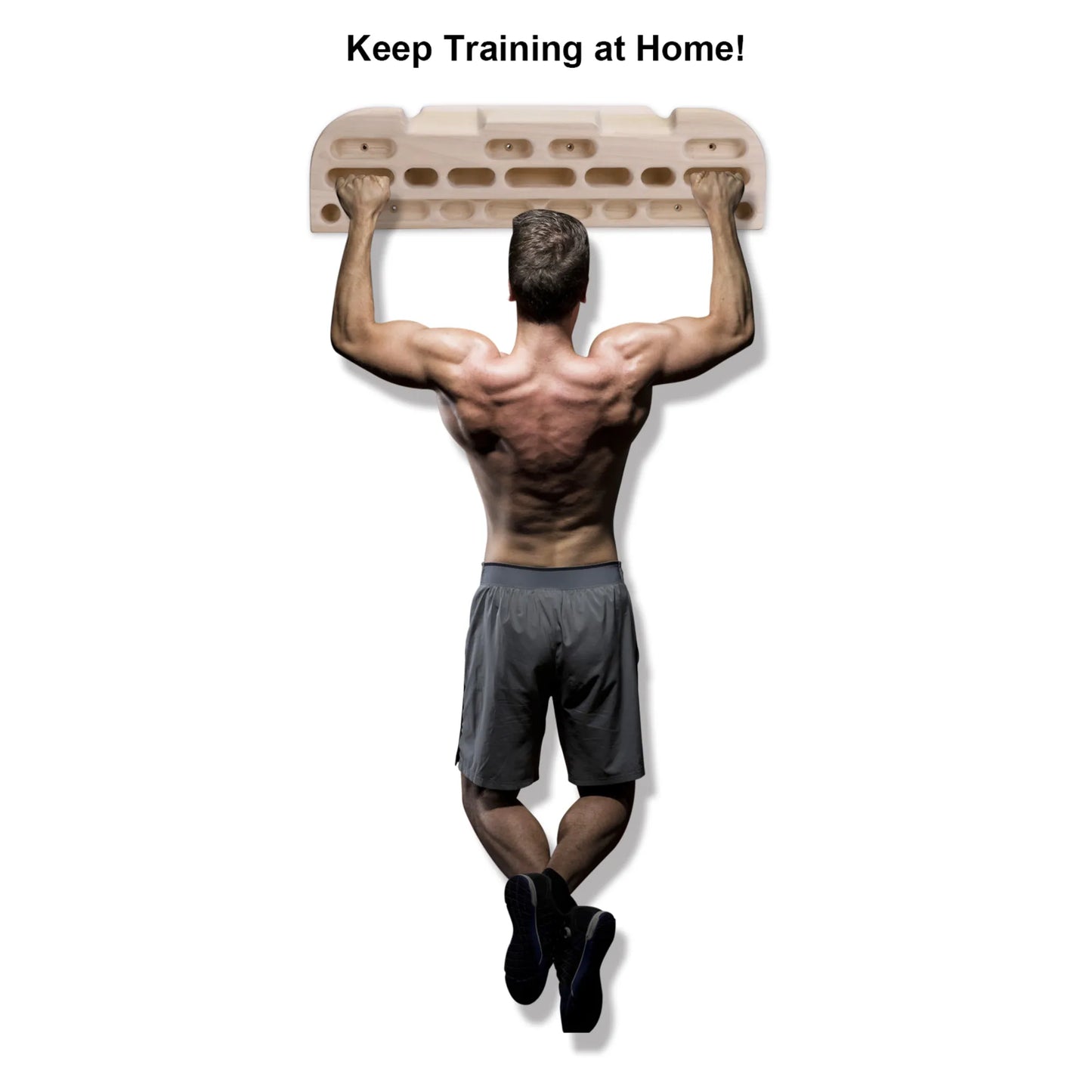 Climber training at home using wooden fingerboard hangboard for grip strength and endurance